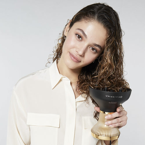 Woman preparing to dry her wet curly hair with the Bellissima Italia Diffon Supreme