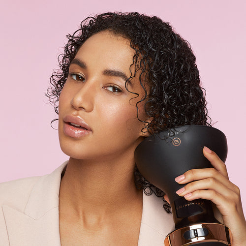 Woman with wet curly hair preparing to dry her hair with the Bellissima Italia Diffon Ceramic