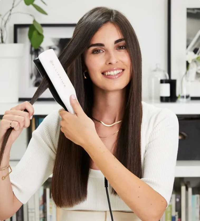 Woman straightening her hair using the Bellissima Steam Elixir Hair Straightener