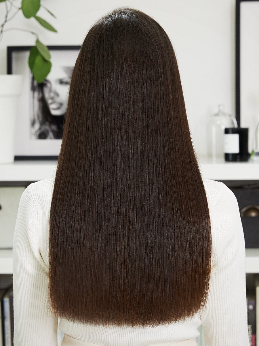 Back view of a woman smoothly straightened hair achieved from Bellissima Steam Elixir hair straightener