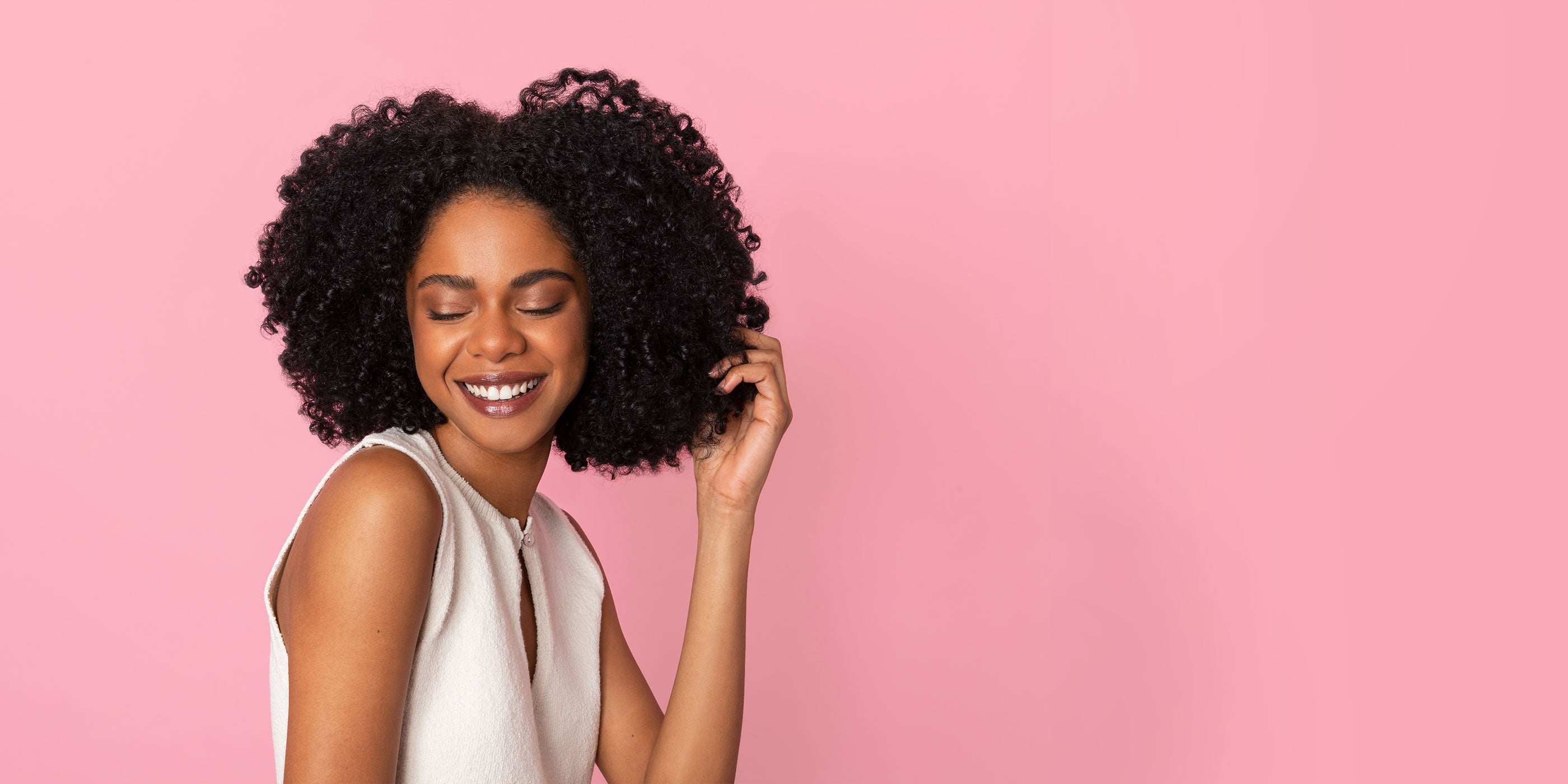 Woman enjoying her freshly diffused curly hair